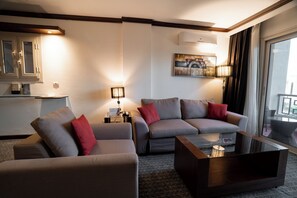 Junior Suite, 1 Queen Bed, Pool View | Living area | 55-inch Smart TV with satellite channels - Panacea Suites Hotel (Borg el Arab)