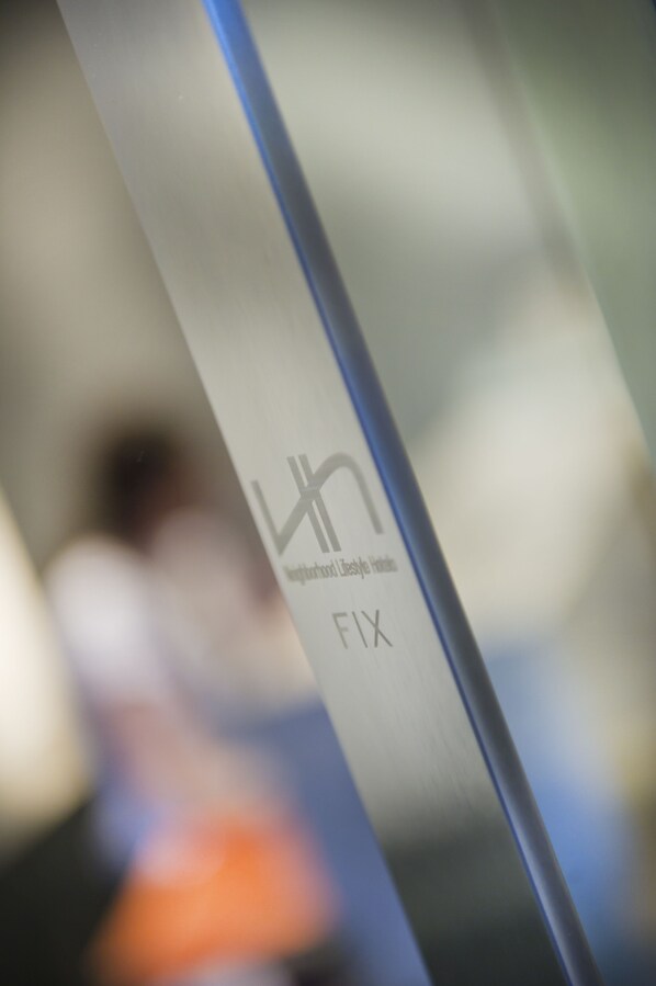 A close-up of a vertical pole with a logo and text.