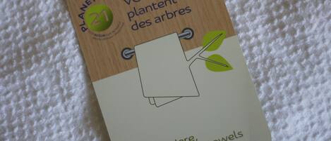 A wooden tag with text and a drawing of a tree.