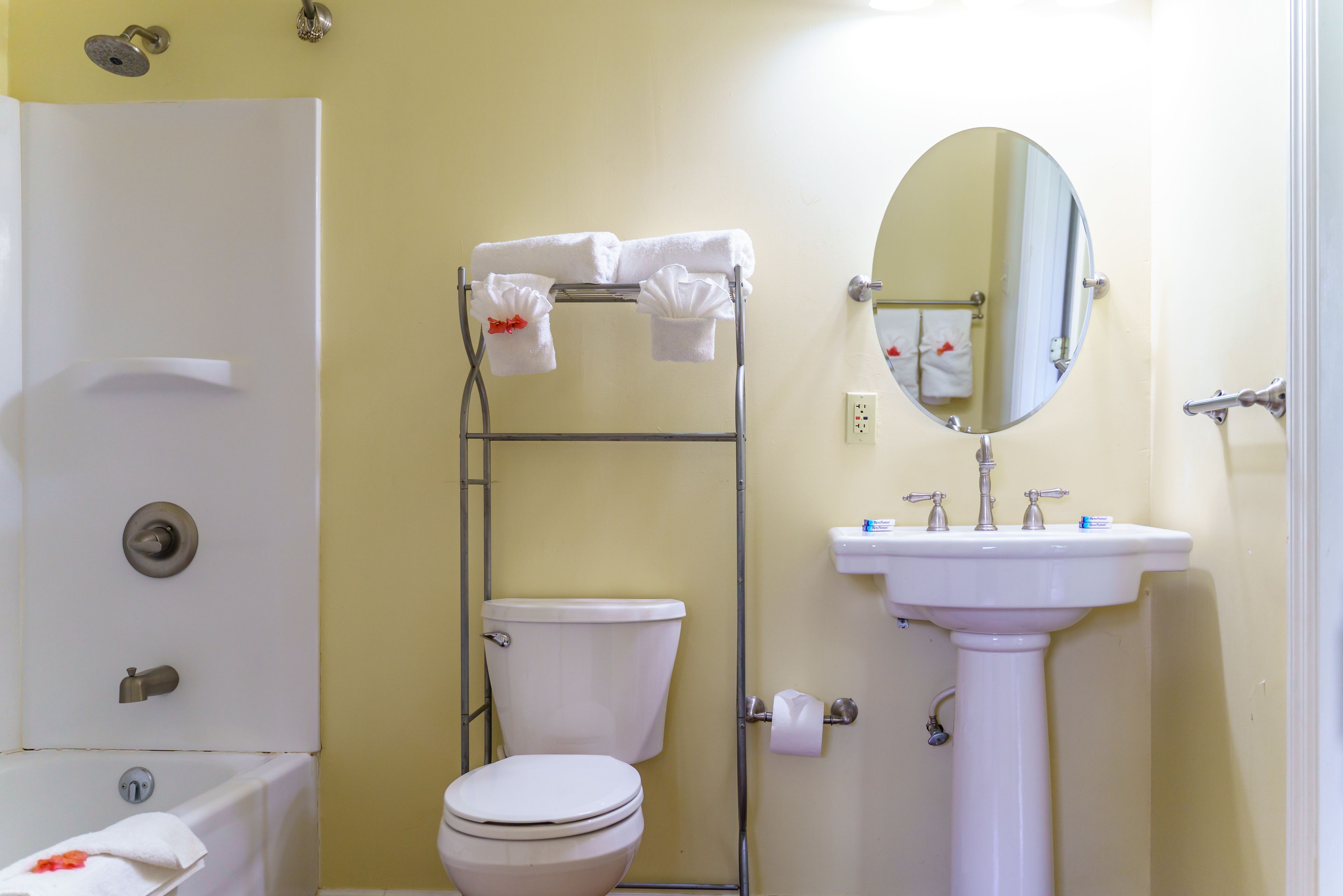 A bathroom with a toilet, sink, and shower.