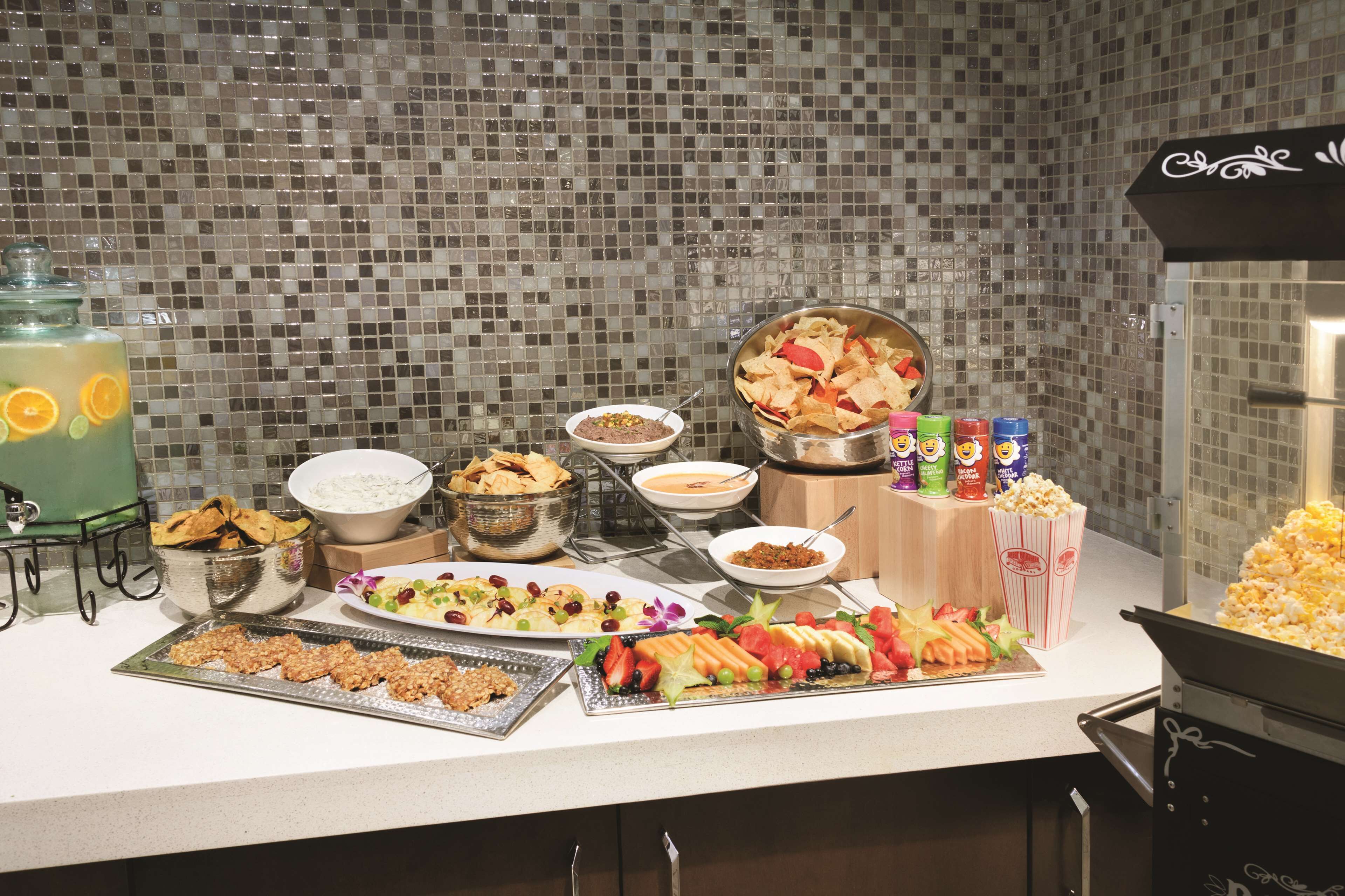 A buffet table with various food items and drinks.