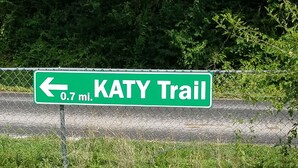 A green directional sign for Katy Trail, indicating it is 0.7 miles away.