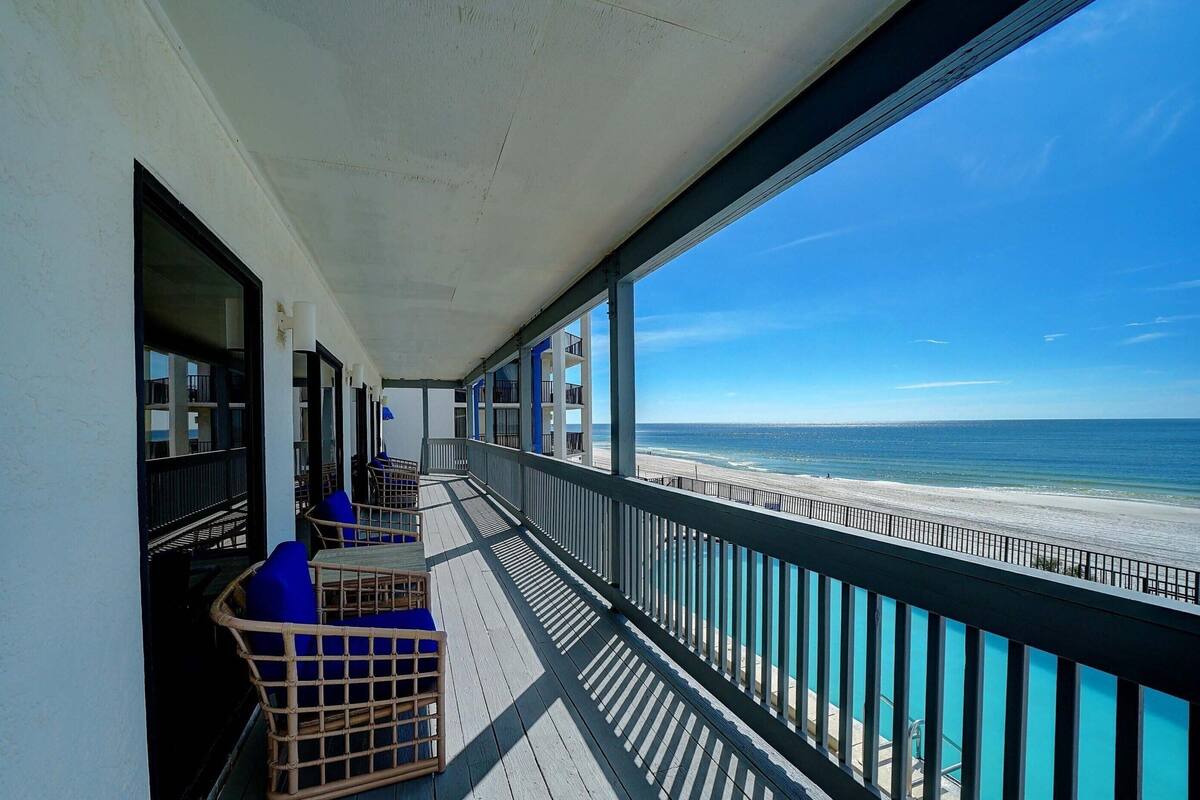 A balcony with a view of the beach.