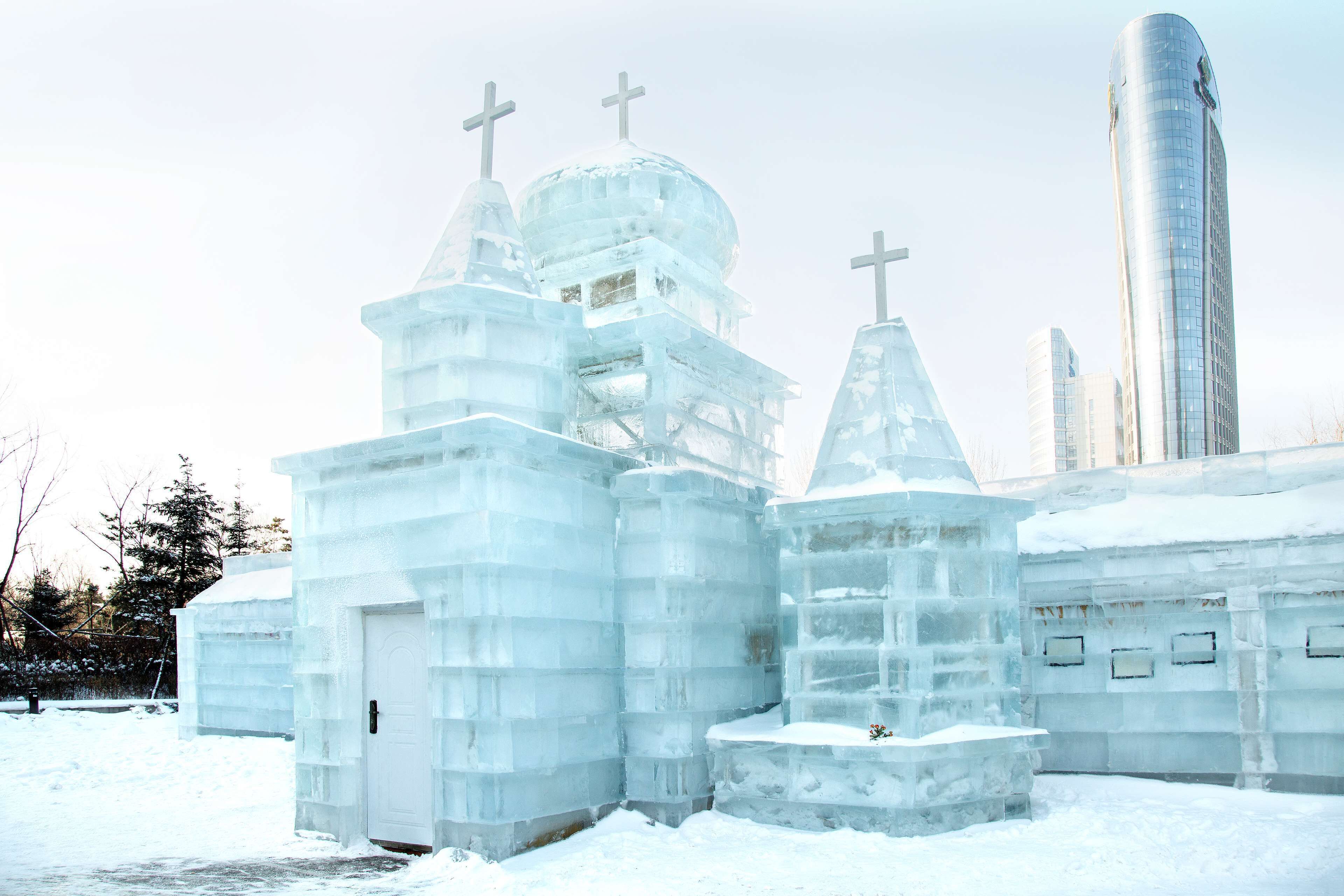 An ice church with multiple domes and crosses, surrounded by snow.