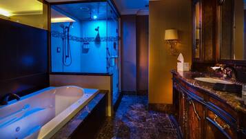 A modern bathroom with a large bathtub, a separate shower area, and a vanity with a mirror.