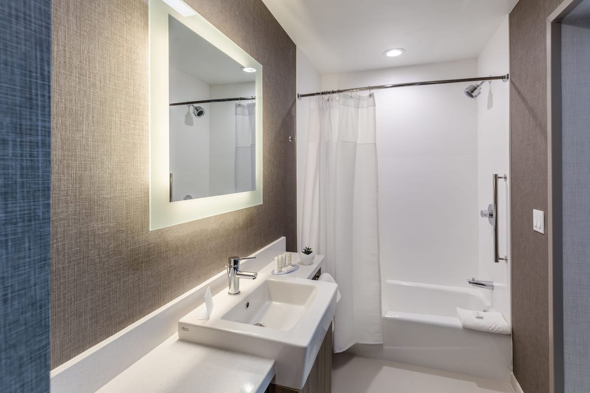 suite, multiple beds | bathroom | deep-soaking bathtub, free toiletries, hair dryer, towels