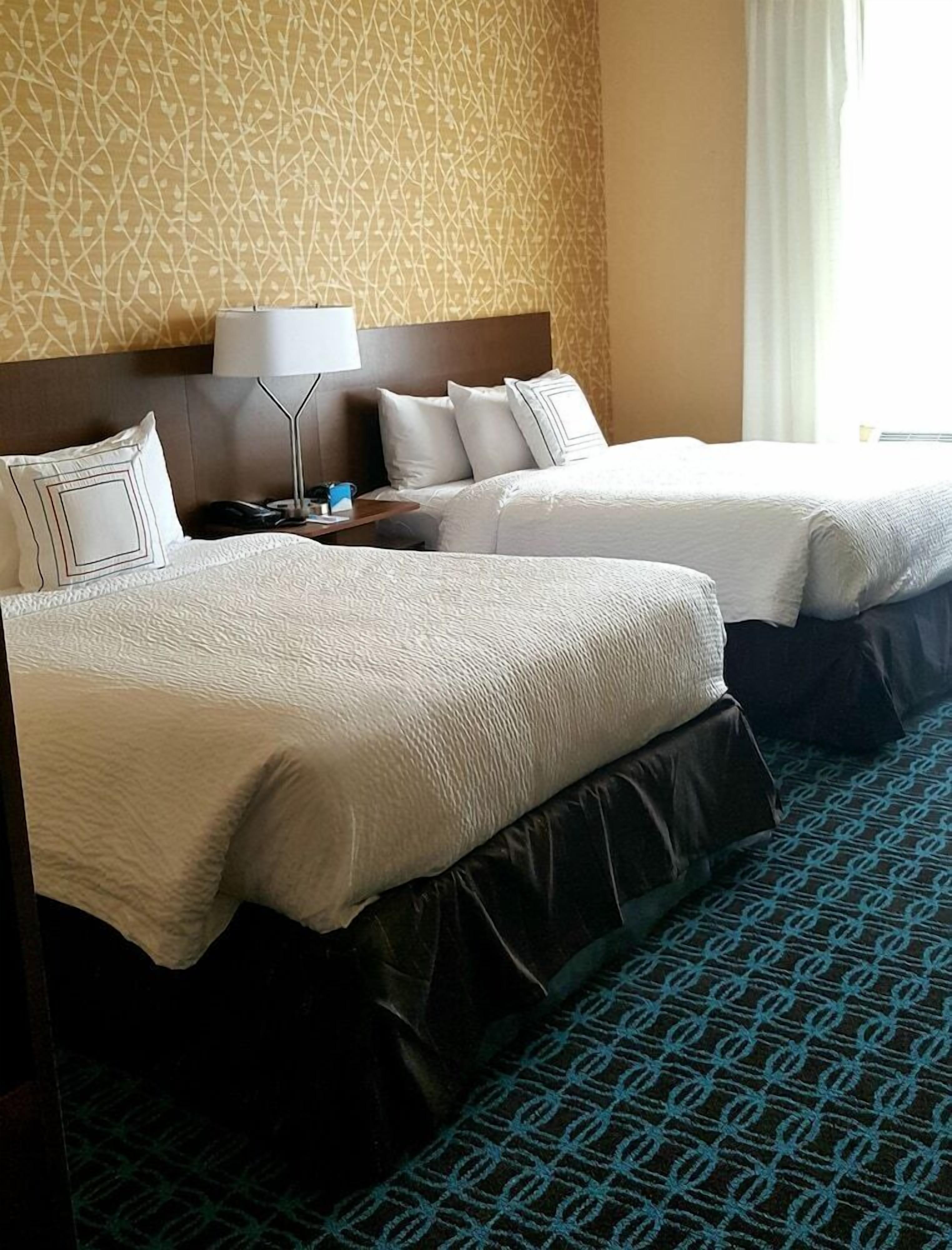 Pillowtop beds, desk, blackout drapes, iron/ironing board