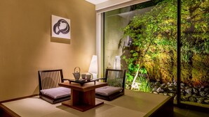 A room with a tatami mat table, two chairs, a tea set, and a wall-mounted artwork. - SOLARIA Nishitetsu Hotel Kyoto Premier (Kyoto)