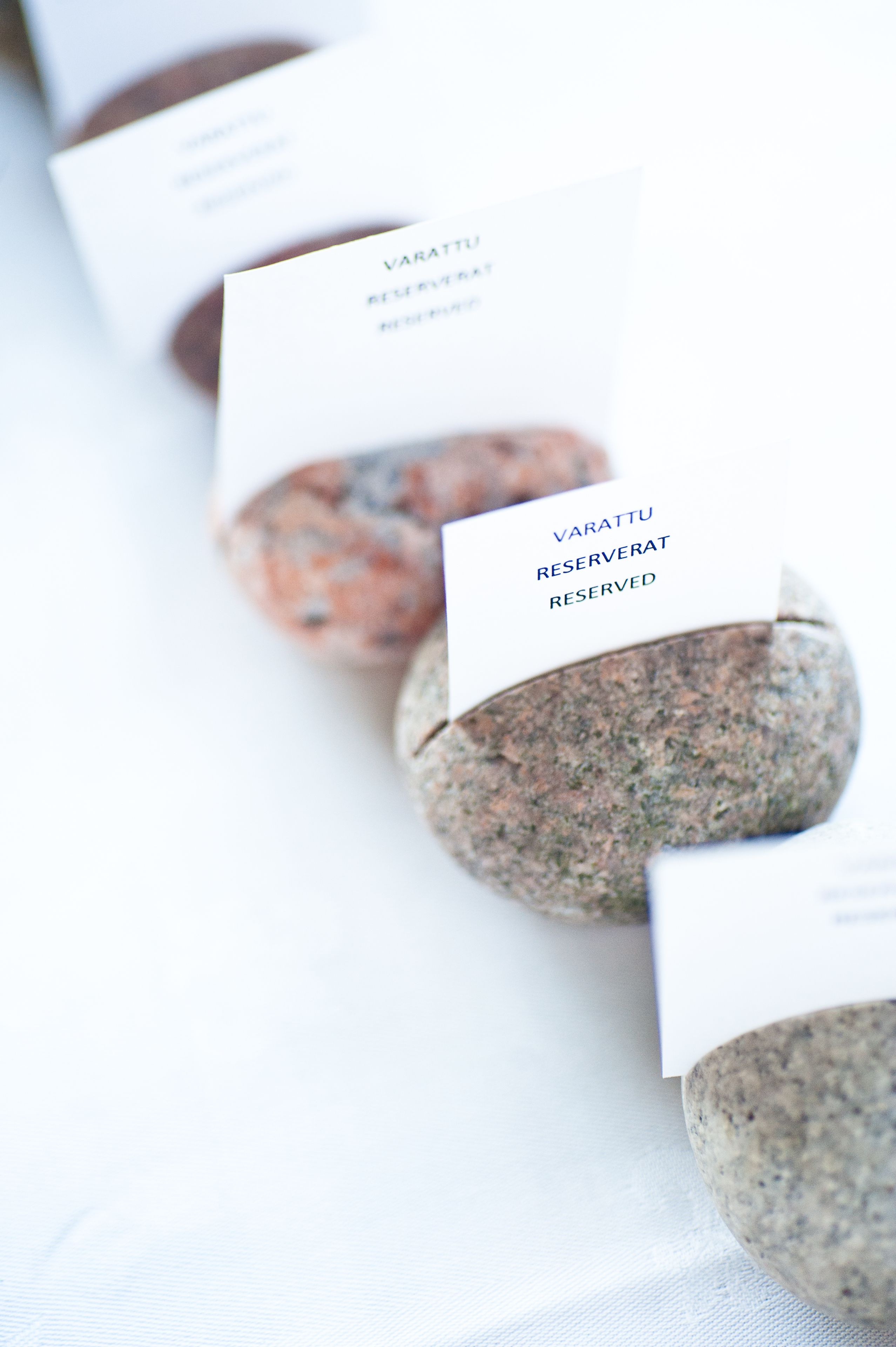 A row of stone coasters with a card on each, labeled "VARATU RESERVED."