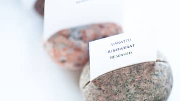 A row of stone coasters with a card on each, labeled "VARATU RESERVED."