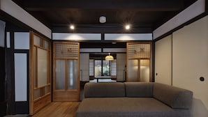 A traditional Japanese room with tatami flooring, a low wooden table, and sliding doors. - Kiyomizu Gojo Ntei (Kyoto)
