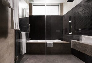 A modern bathroom with a glass shower enclosure, a freestanding bathtub, and a vanity with a sink. - Bopha Residence (Siem Reap)