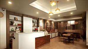 A modern kitchen with a central island, wooden cabinets, and pendant lighting. - Link Mansion (Chiang Mai)