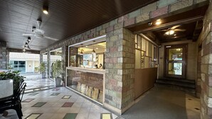 A spacious lobby with a tiled floor, a reception desk, and a staircase leading to an upper level. - Link Mansion (Chiang Mai)