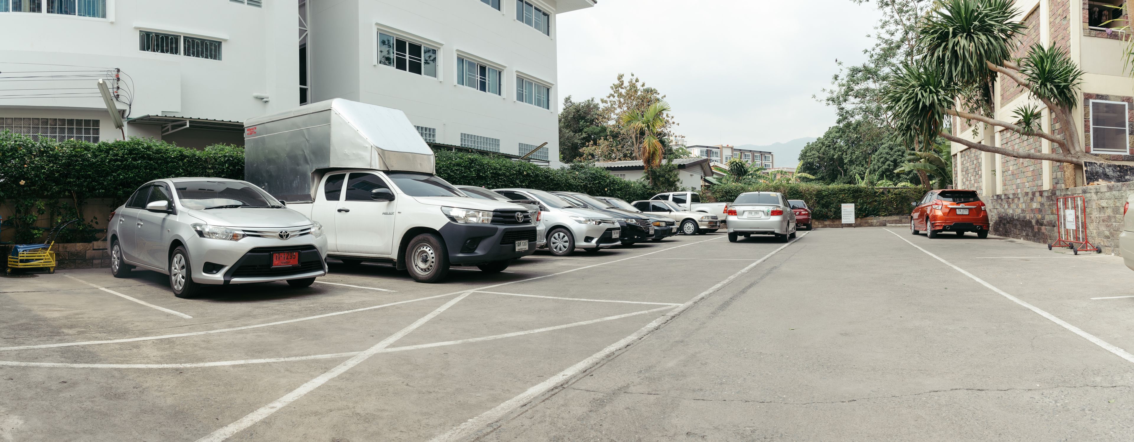 A parking lot with multiple cars and a white truck.