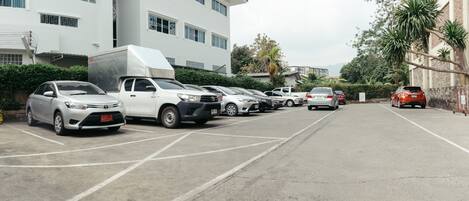 A parking lot with multiple cars and a white truck.