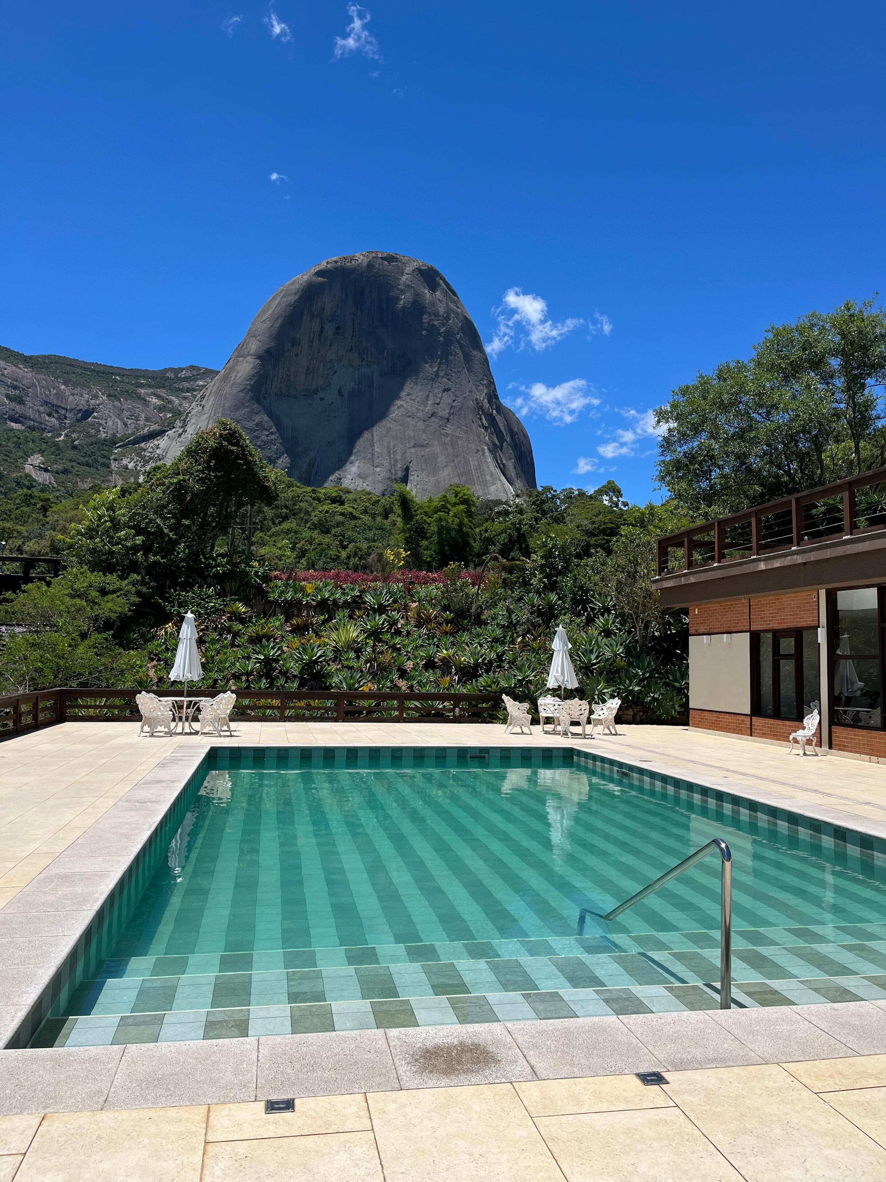 A swimming pool with a view of a large mountain.