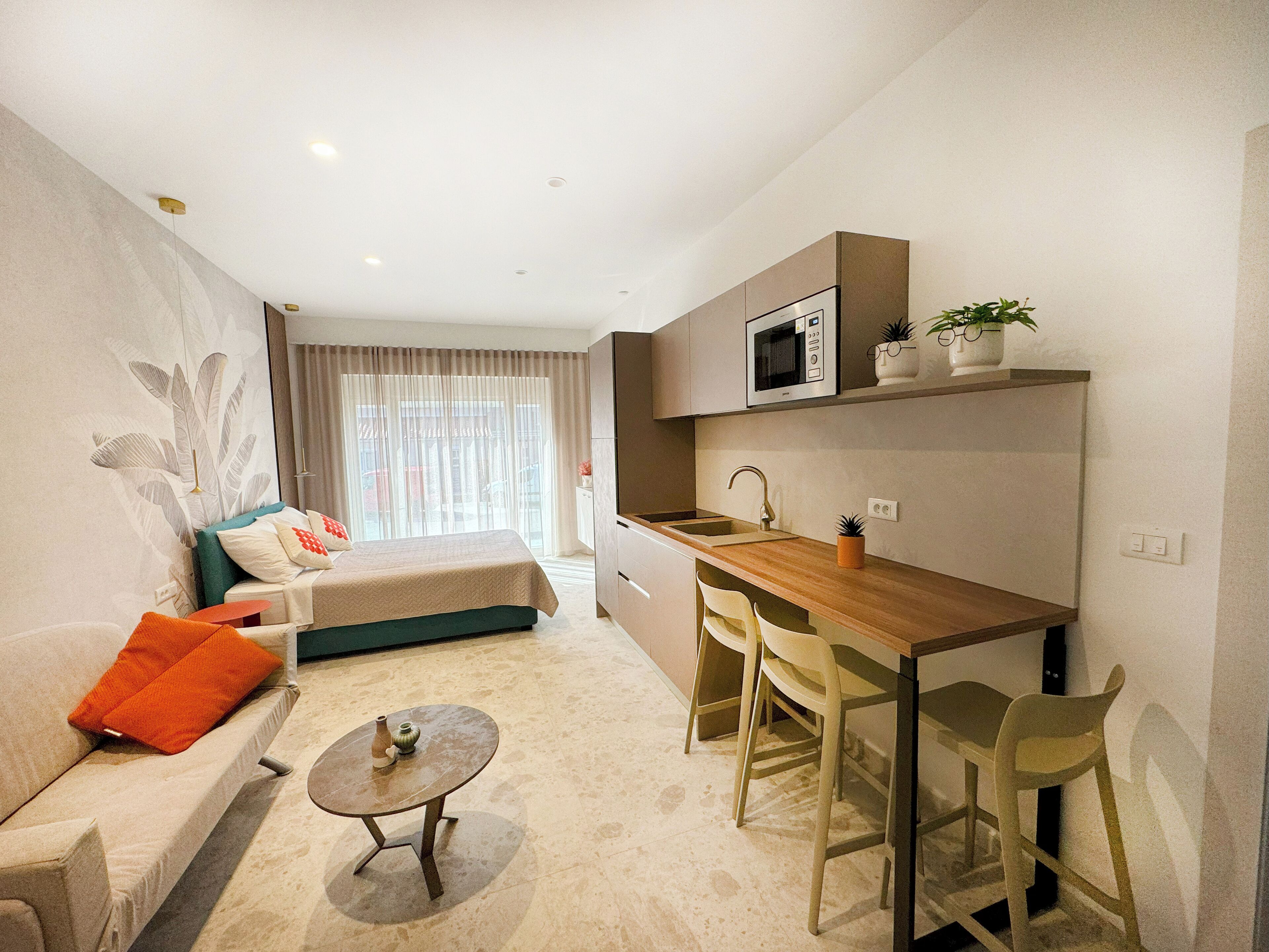 A modern apartment with a living area, a kitchen, and a dining space.