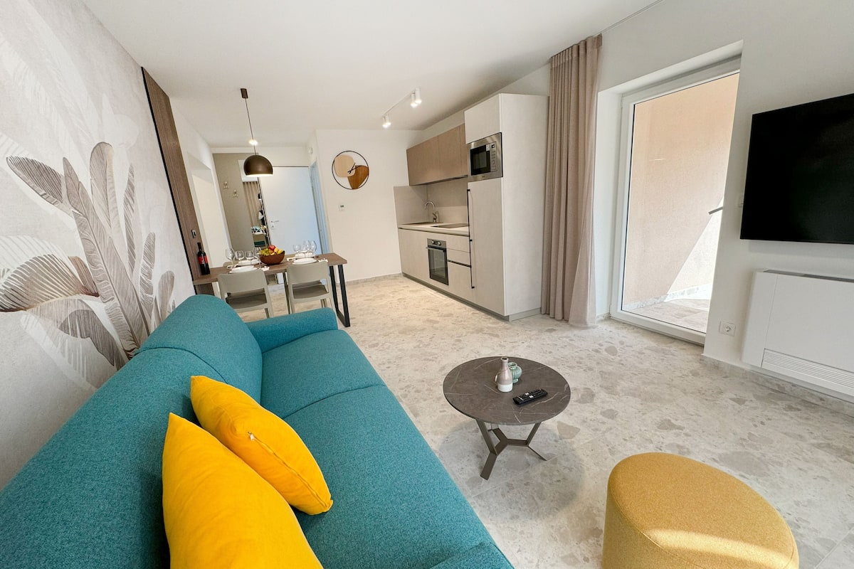 superior apartment, 1 bedroom, balcony, sea view | living area | 60-inch flat-screen tv with satellite channels, tv