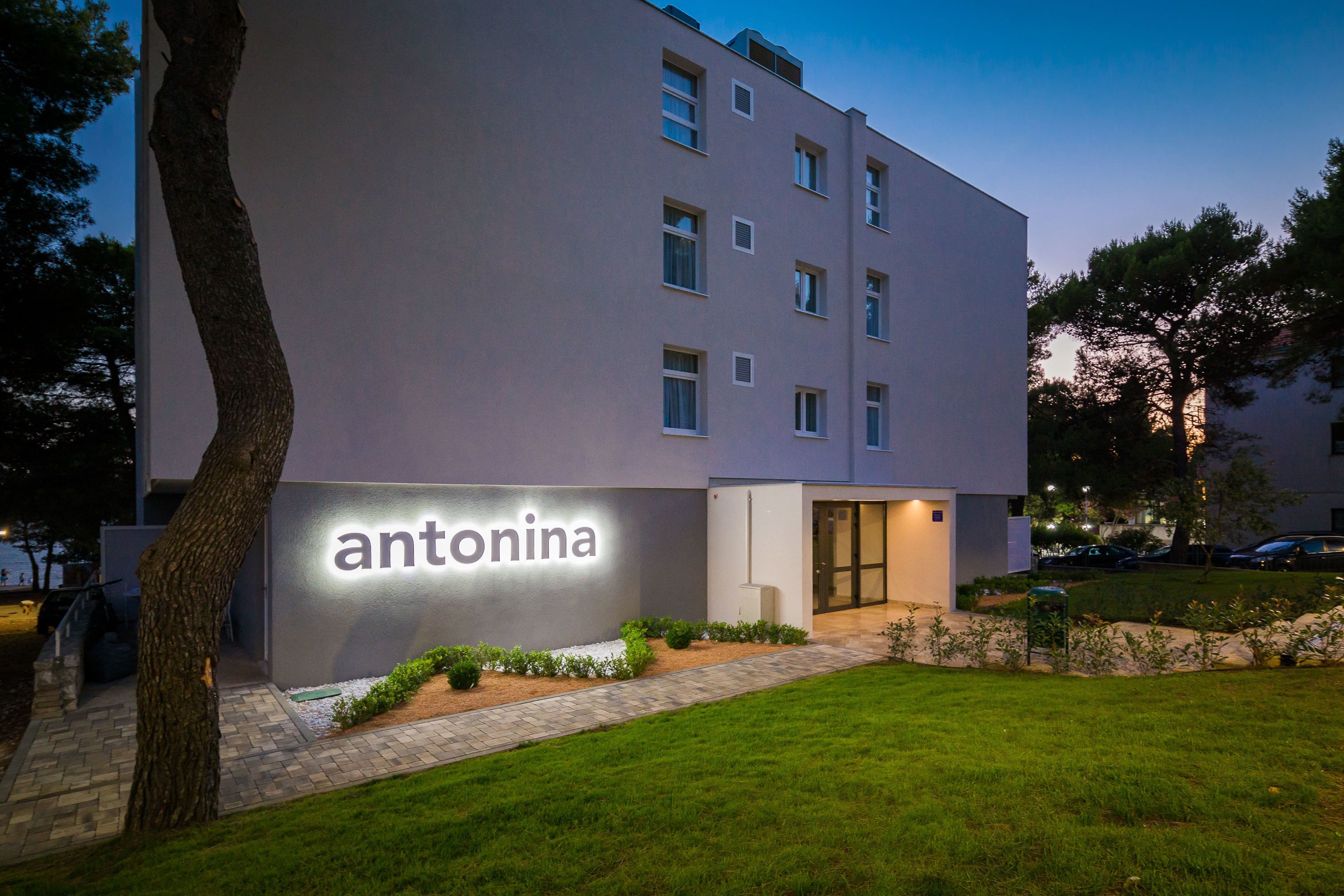A modern building with a sign reading "antonina" on the facade.