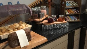A buffet setup with various food items and condiments. - De Wapser Herberg (Wapse)