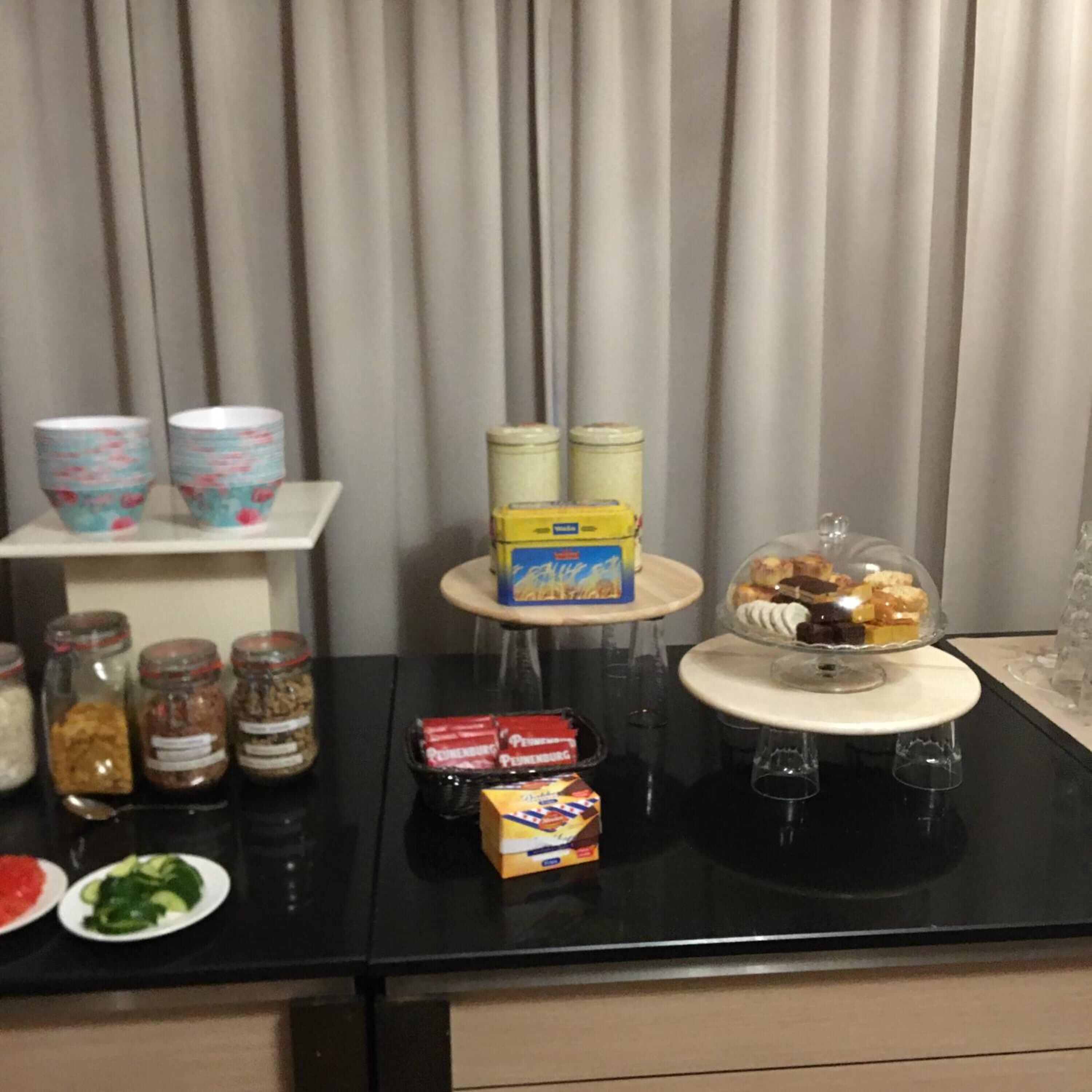 A breakfast buffet setup with various food items and condiments.