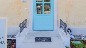 A hotel entrance with a blue door, turquoise shutters, and a sign reading "Hotel CHERSIN". - Heritage hotel Chersin (Fazana)