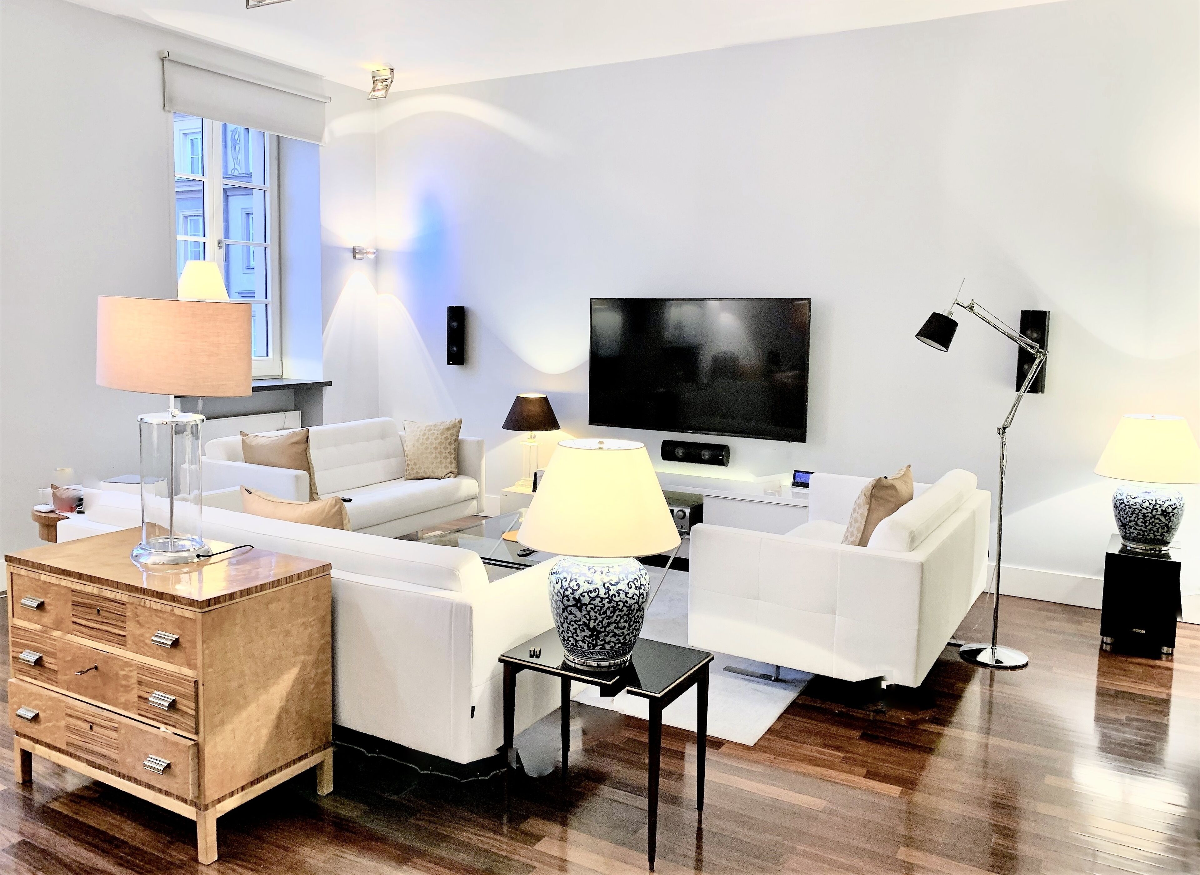 Una sala de estar moderna con un conjunto de sofá, un televisor y un aparador de madera.