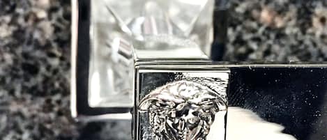 A close-up of a metallic object with a textured surface, possibly a part of a piece of furniture or equipment.