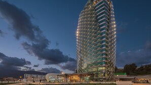 A modern hotel with a distinctive geometric facade, multiple floors, and a prominent entrance area. - Sheraton Annaba Hotel (Annaba)