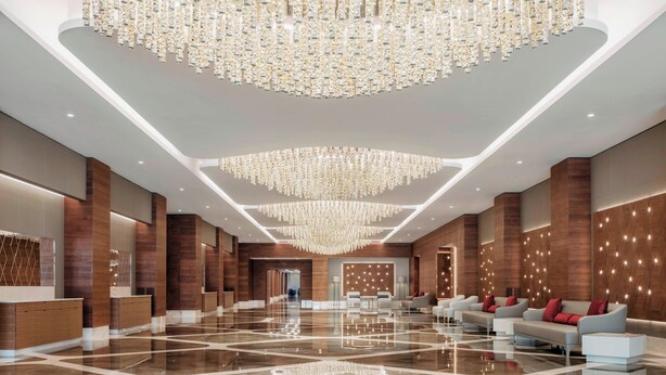 A spacious lobby with a reflective floor, modern seating, and a large chandelier. - Sheraton Annaba Hotel (Annaba)