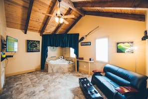 Deluxe Cottage, 1 King Bed, Jetted Tub | Living room | 43-inch flat-screen TV with cable/satellite TV channels, TV, DVD player - Hogsveil Cottages - Harry Potter Themed (Eureka Springs)
