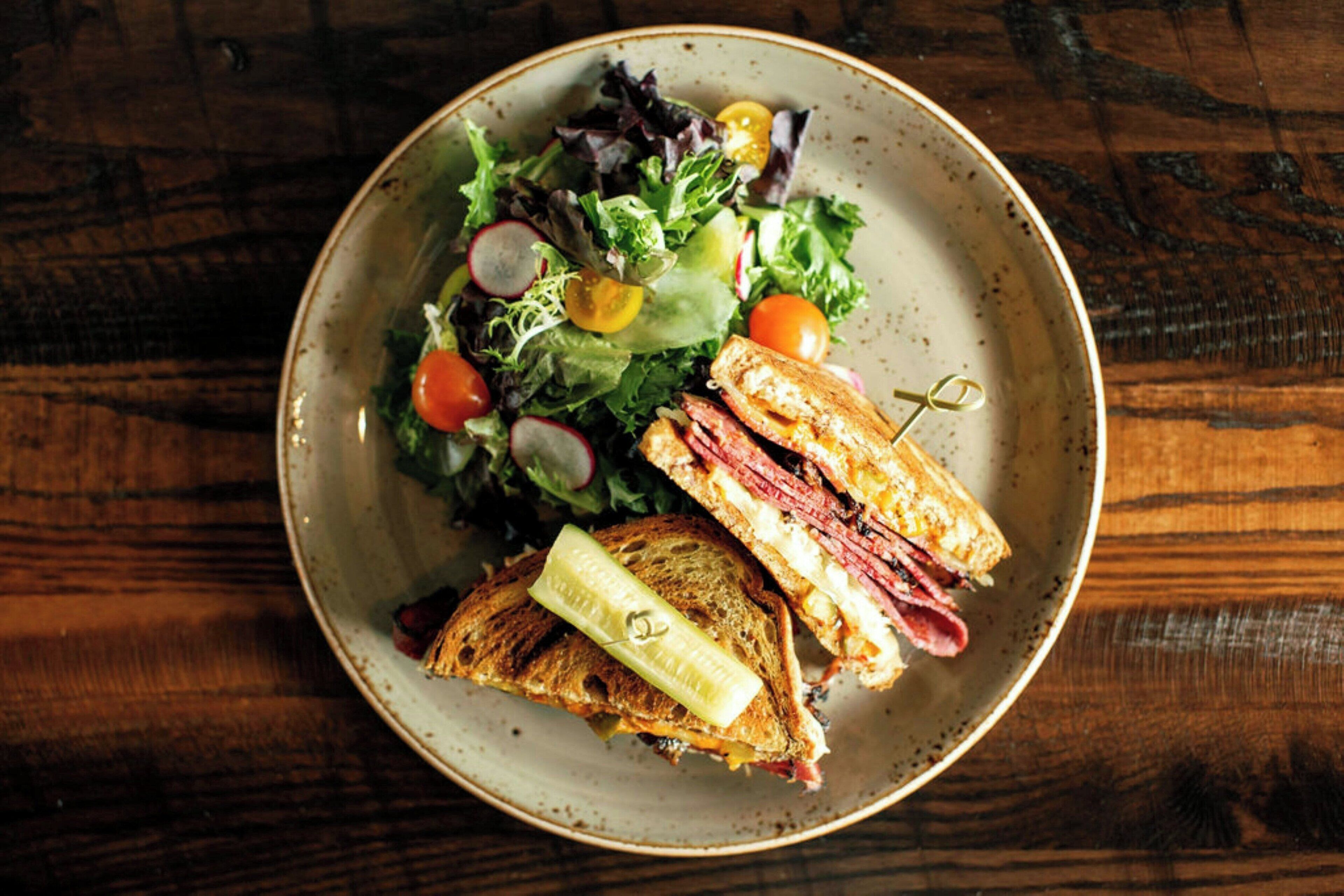 A plate with a sandwich and salad.