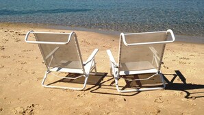 Two beach chairs facing the sea with a clear view of the shoreline and distant land. - Good Harbor Bay Estate, Lake Michigan (Lake Leelanau)