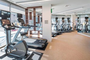 A gym with treadmills, stationary bikes, and exercise equipment. - Residence Inn by Marriott Jersey City (Jersey City)
