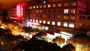 A multi-story hotel with illuminated signage and a prominent entrance.