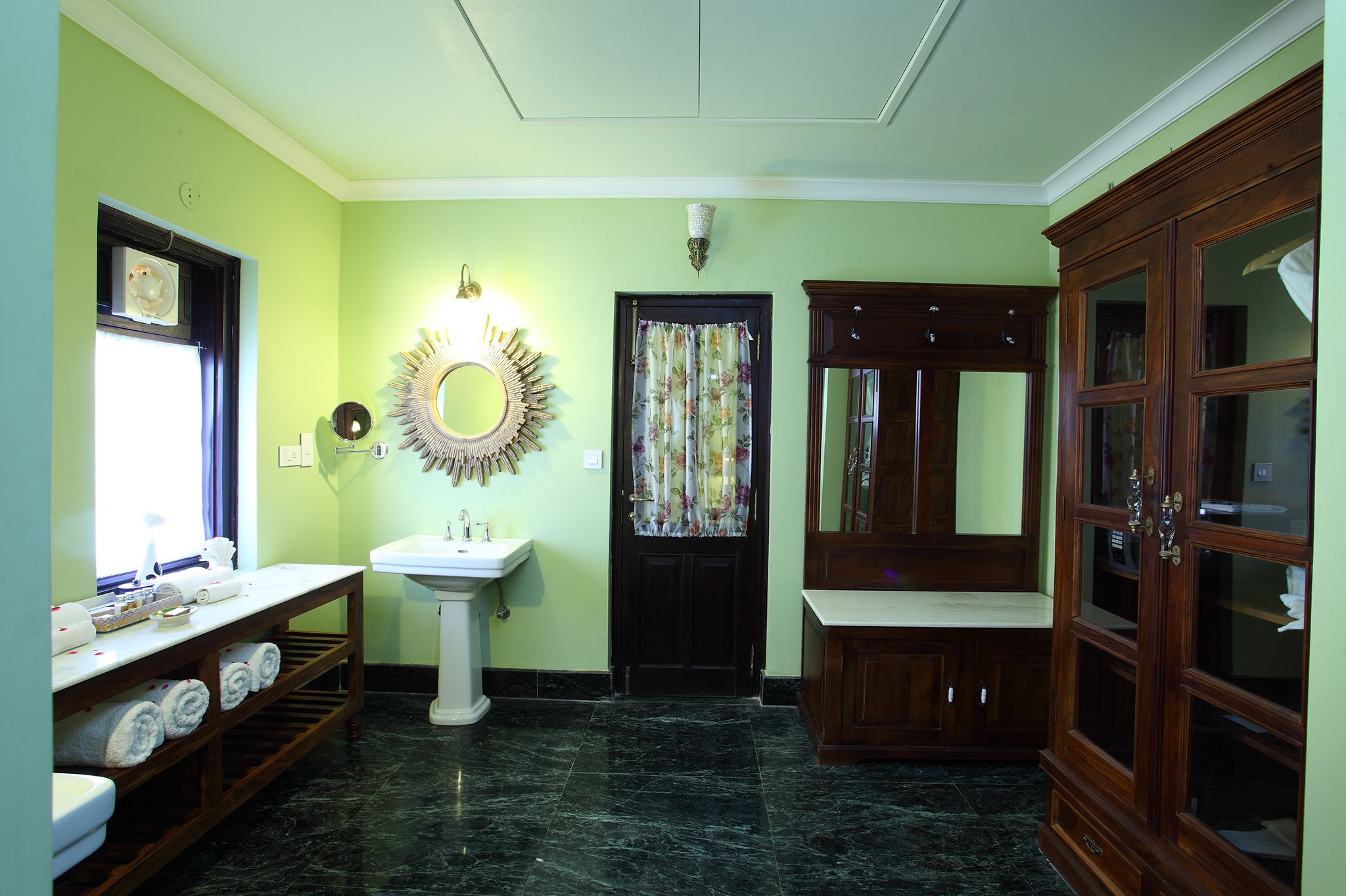 A bathroom with a sink, mirror, and wooden cabinet.