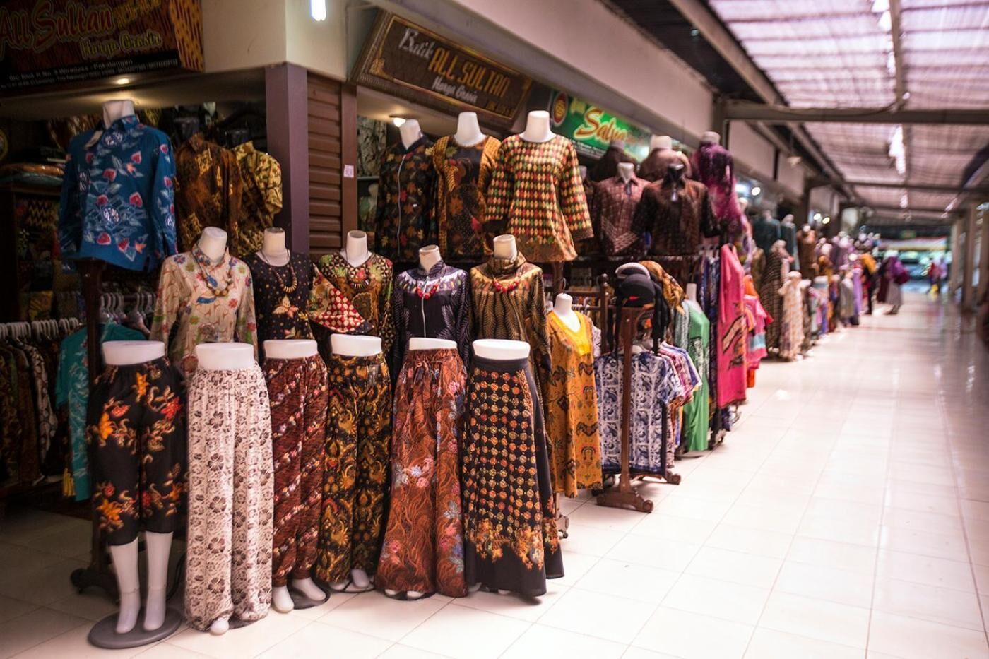 A clothing store with mannequins displaying various traditional garments.