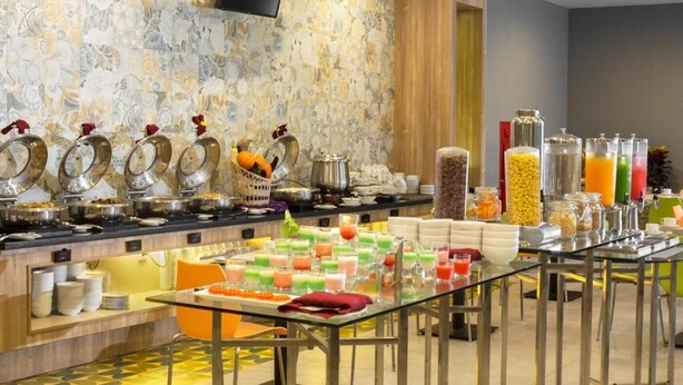 A buffet setup with various food and drink options, including fruits, cereals, and beverages. - Khas Pekalongan (Pekalongan)