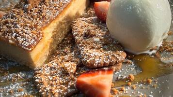 A dessert plate with a slice of cake, a scoop of ice cream, and strawberries.