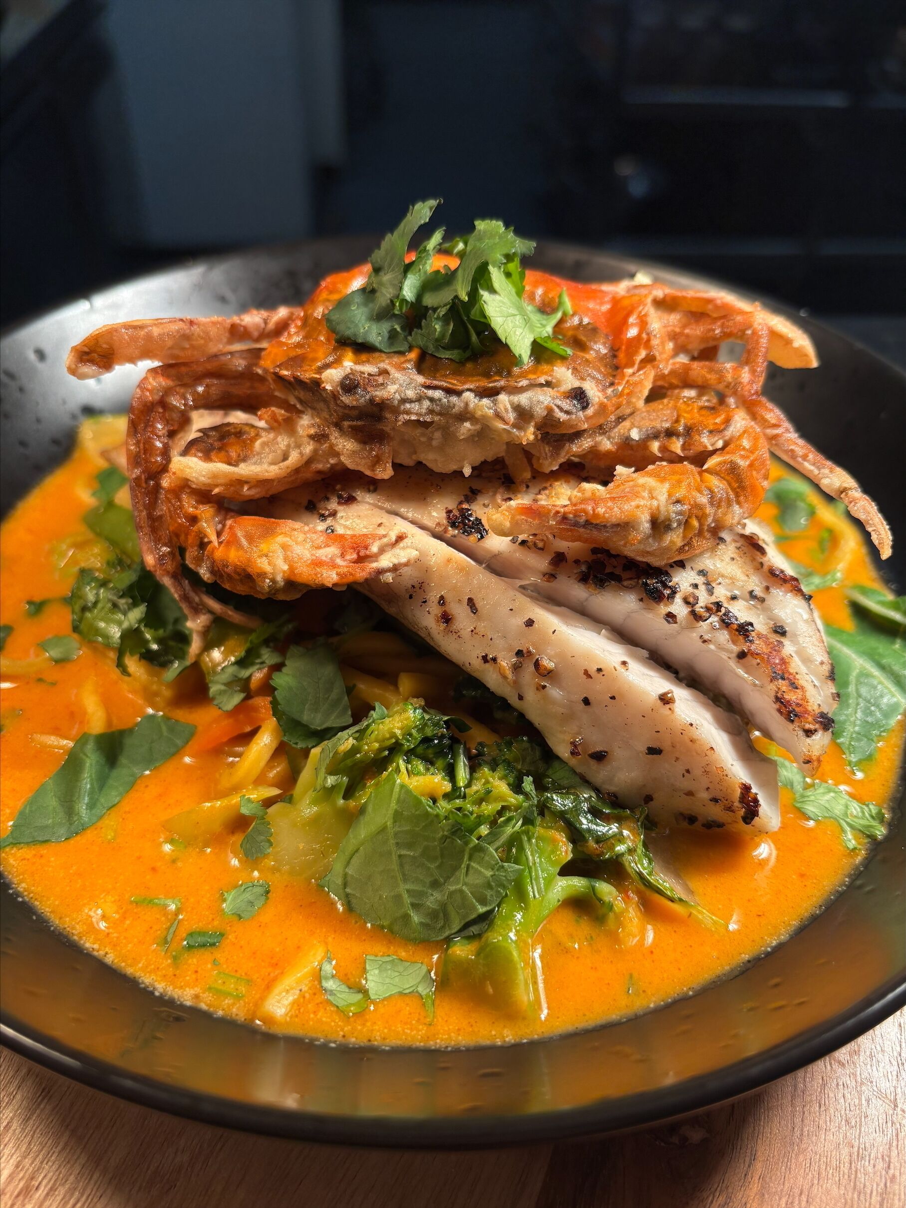 A dish with seafood and vegetables in a bowl.
