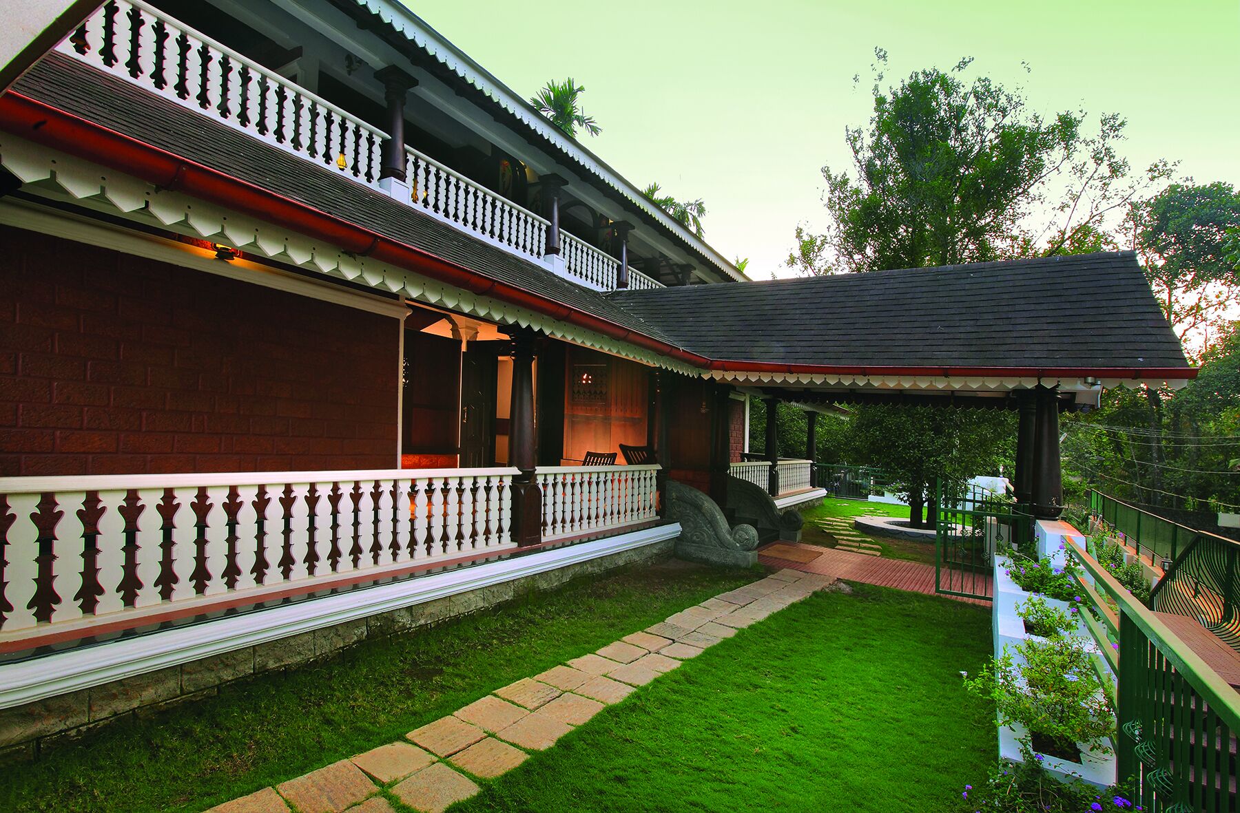 A traditional building with a covered porch and a well-maintained lawn.