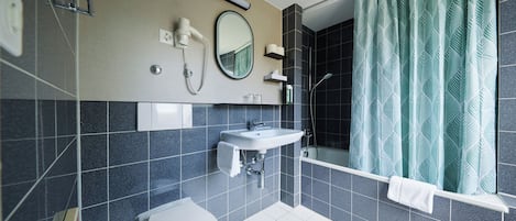 A modern bathroom with a toilet, sink, and shower.