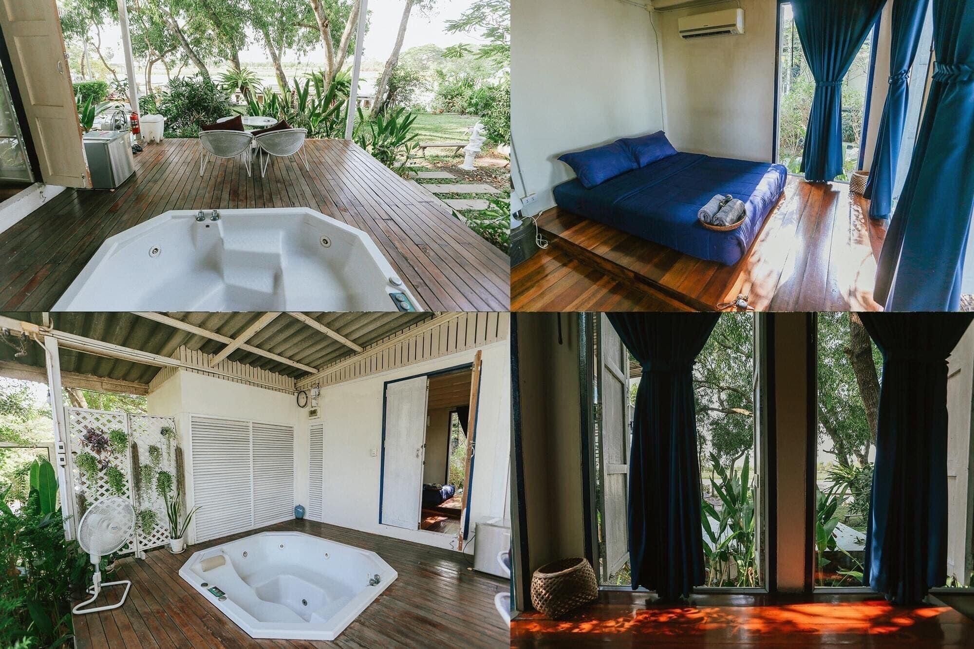 Una habitación con terraza de madera, jacuzzi, sofá y un ventanal con cortinas.