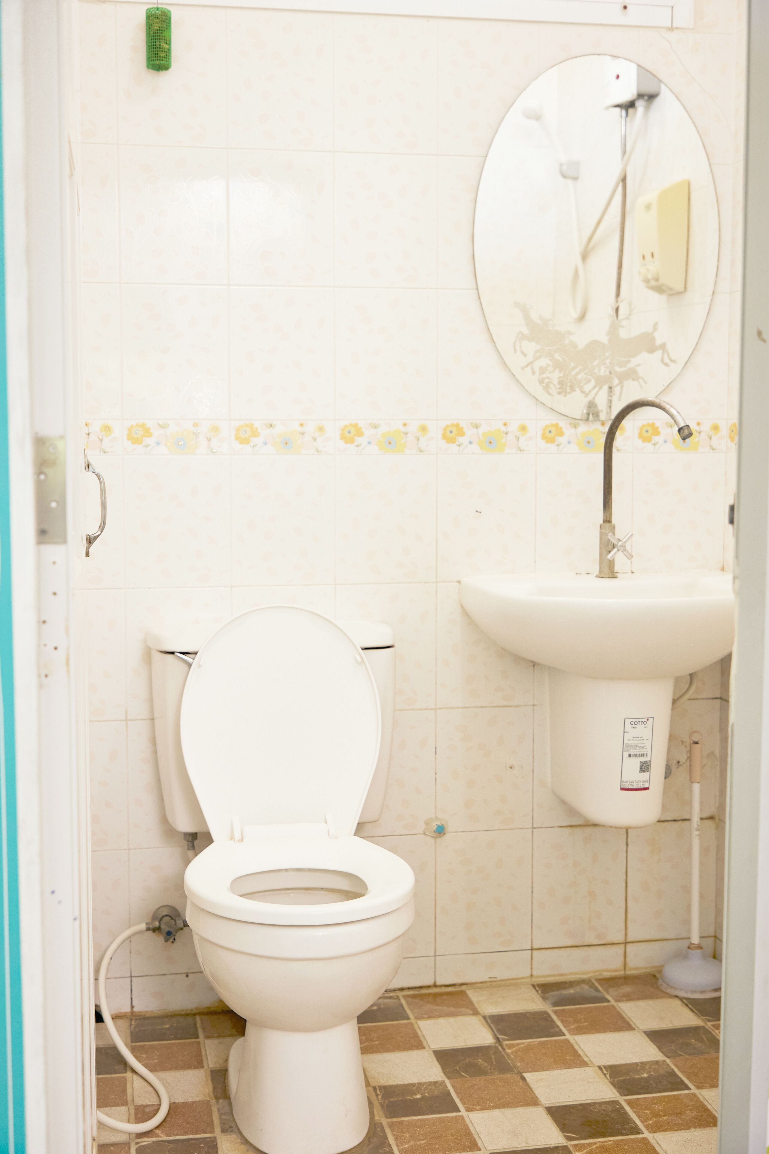 A bathroom with a toilet, sink, and shower.