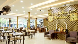 A spacious dining area with tables and chairs, a reception desk, and a wall with a 'Welcome to Bandarana Resort Thailand' sign. - Baandara Resort Saraburi (Saraburi)