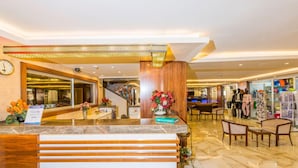 A hotel reception area with a marble counter, a clock, and a staircase leading to other floors. - Lavinia Apart Hotel (Alanya)