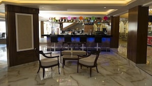 A modern bar area with marble flooring, bar stools, and a counter with various items. - Lavinia Apart Hotel (Alanya)