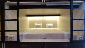 Premium bedding, desk, laptop workspace, soundproofing
