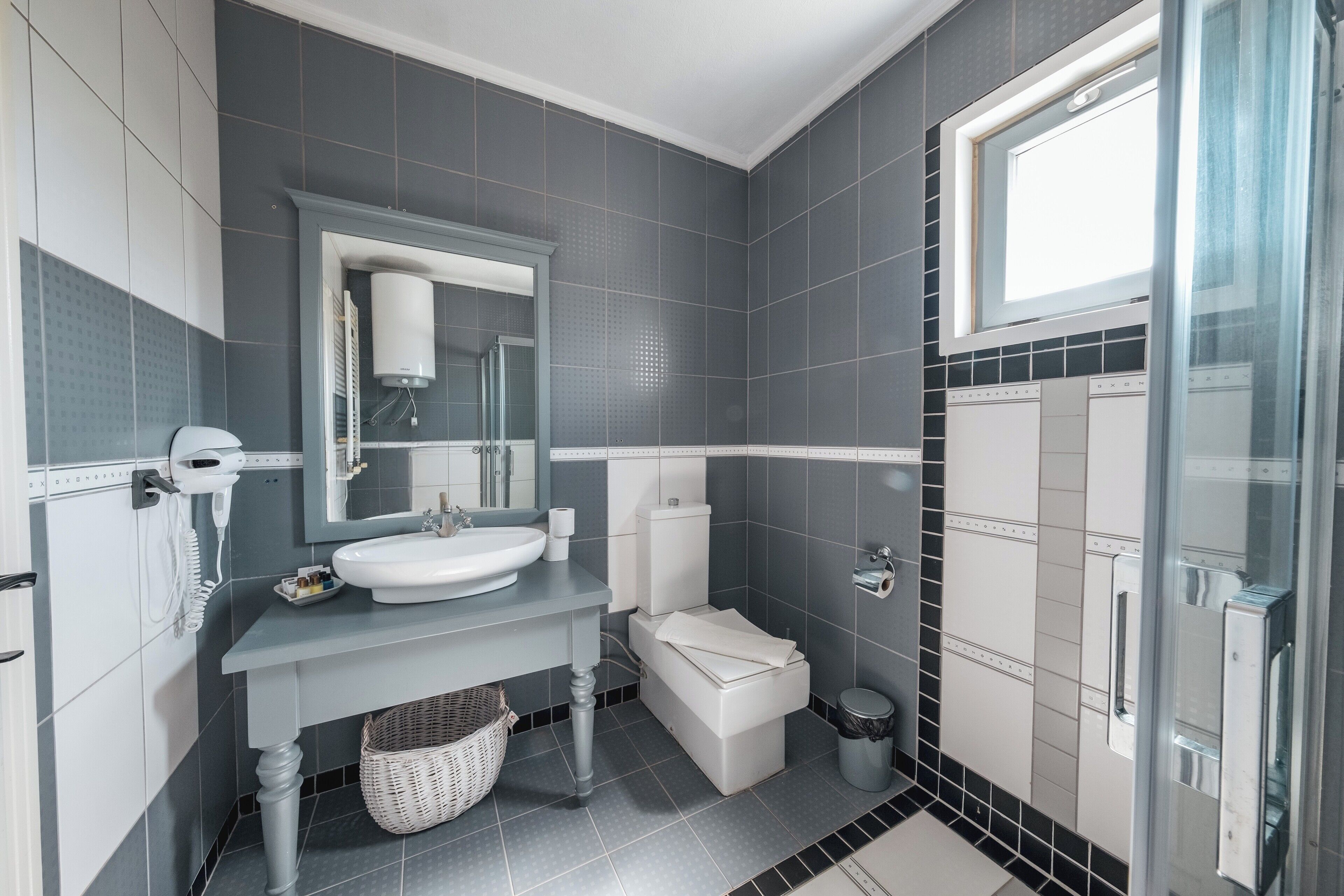 luxury studio suite | bathroom | shower, rainfall showerhead, free toiletries, hair dryer